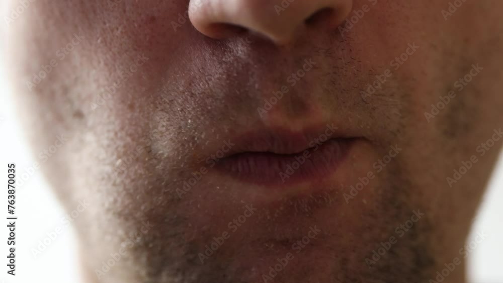 Man's mouth grimaces at camera. Slight unshaven face Man's mouth grimaces at camera. Slight unshaven face