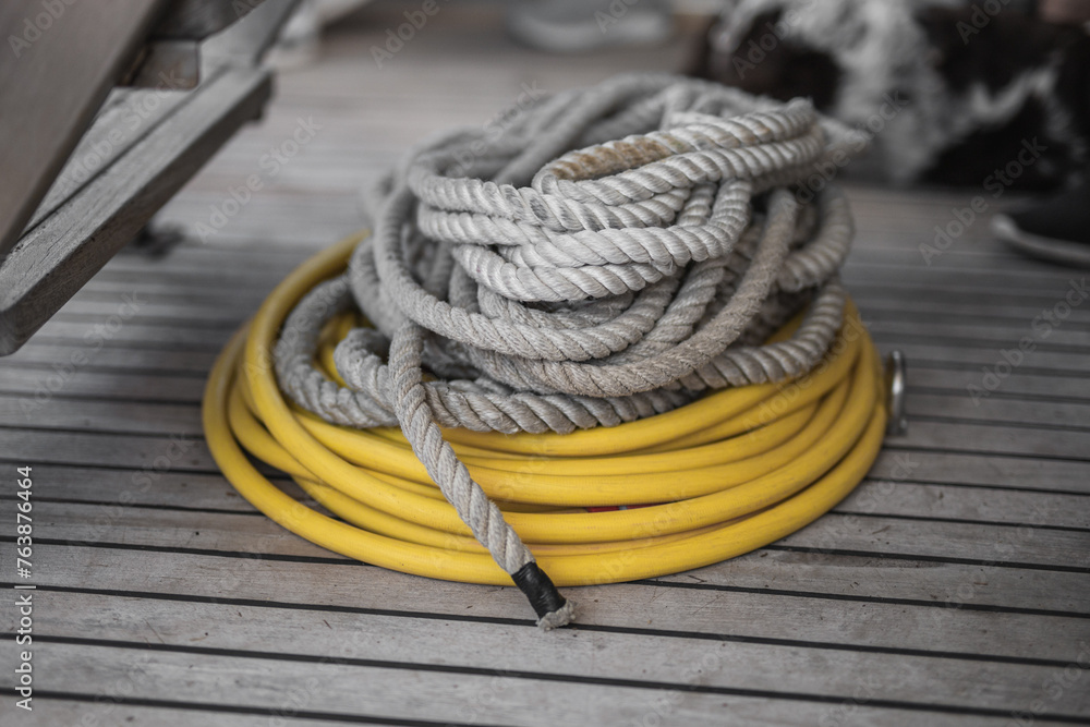 A coil of rough ship rope on the deck - mooring rope