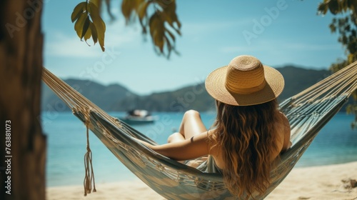 Traveler woman relaxing in a hammock on a summer beach