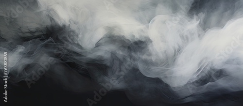 Smoke swirls in the air on a black background, creating a mysterious and atmospheric scene