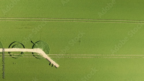 Destroyed Winterbourne Bassett crop circle aerial dolly view looking down over Wiltshire barley field pattern photo