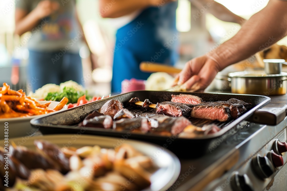 empty tabletop with hands preparing bbq dishes in soft focus behind empty tabletop with hands preparing bbq dishes in soft focus behind