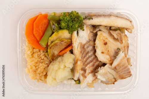 Healthy fish packed lunch box meal in front top aerial view clean white background