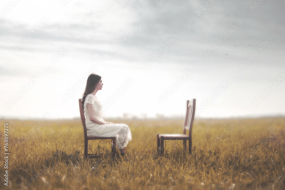 sad woman sitting in front of her lover's empty chair, loneliness concept