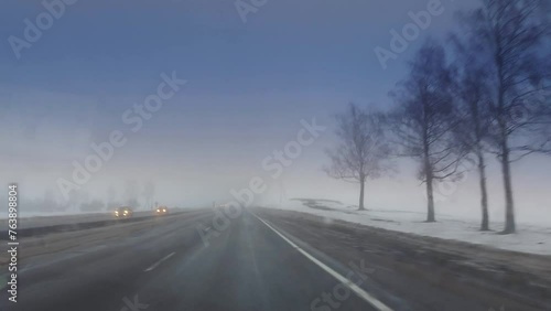 Wallpaper Mural View from the windshield of a car on the road in winter in bad weather with fog and poor visibility. Encountered cars with headlights on. Snowy roadsides. Copy space for text Torontodigital.ca