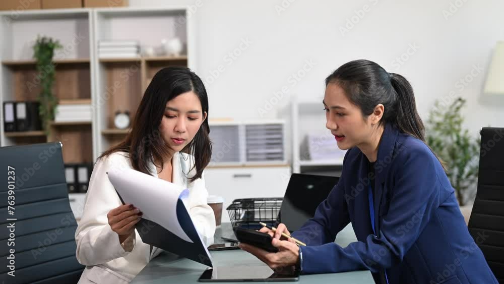 Businesswoman leading team meeting and using tablet and laptop computer with financial in office Businesswoman leading team meeting and using tablet and laptop computer with financial in office