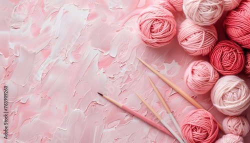 Pink balls of wool and yarn for crocheting and knitting on a pink background. Banner with space for your text.