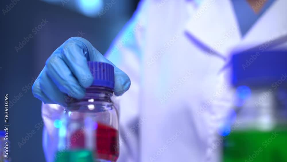 Life scientists researching in laboratory. Focused female life science professional pipetting solution into the glass cuvette. Healthcare and biotechnology concept. Life scientists researching in laboratory. Focused female life science professional pipetting solution into the glass cuvette. Healthcare and biotechnology concept.