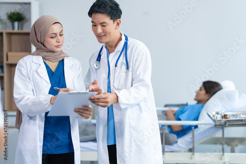 Two conficent doctor or specialist of kidney cancer talking together with female mix race patient on bed at medical ward  checkup  recovering after successful surgery concept.