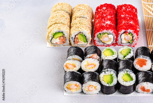Popular types of sushi. Set of sushi roll on a gray background.