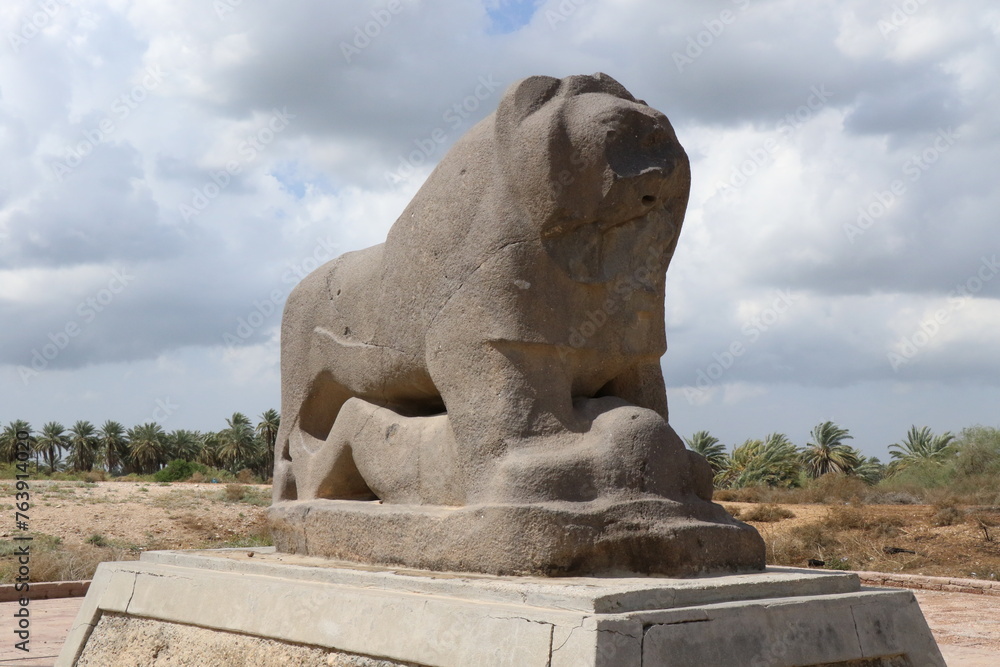 Several perspectives of the Lion of Babylon statue in the ancient city of Babylon on a cloudy day