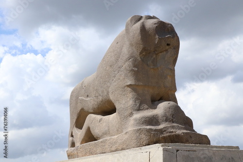 Several perspectives of the Lion of Babylon statue in the ancient city of Babylon on a cloudy day photo