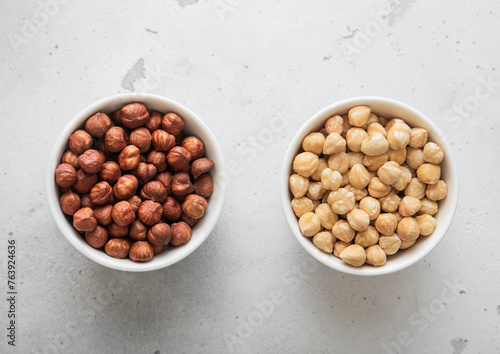 Peeled and blanched healthy hazelnut nuts on light background.Top view.