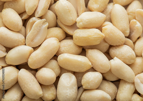 Healthy blanched peanut nuts top view macro background.Top view. © DenisMArt