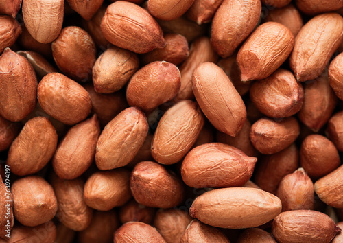 Raw peeled red peanut nuts top view macro background.Top view. © DenisMArt