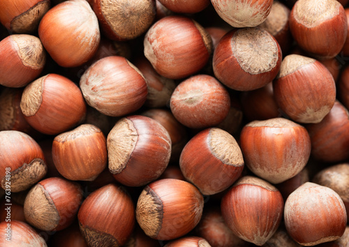 Raw healthy whole hazelnut nuts top view macro background.Top view. © DenisMArt
