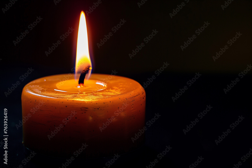 burning candle on black background burning candle on black background