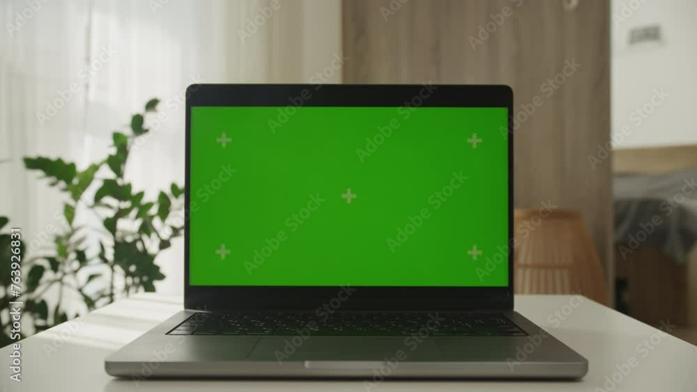 Dolly Zoom Laptop with Green Screen in Modern Workspace Dolly Zoom Laptop with Green Screen in Modern Workspace