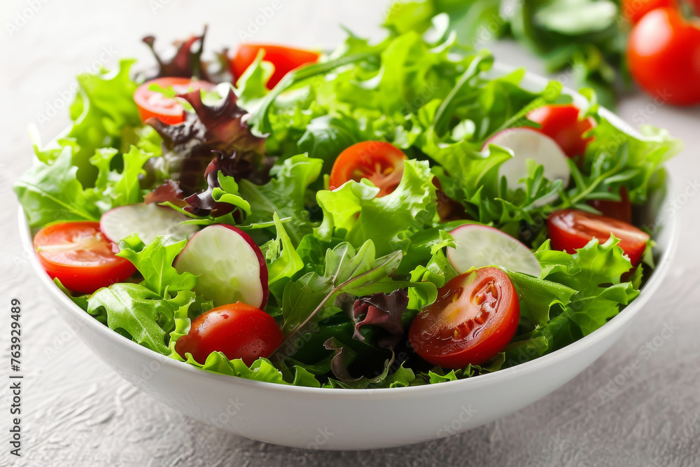 A bowl of fresh vegetable salad with succulent cherry tomatoes, crisp cucumbers, and mixed greens on a light background A bowl of fresh vegetable salad with succulent cherry tomatoes, crisp cucumbers, and mixed greens on a light background