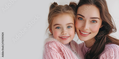 Loving mother hugging daughter. Banner with copyspace.