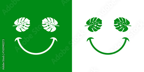 Logo con silueta de emoticono con cara con hojas de monstera como ojos y sonrisa