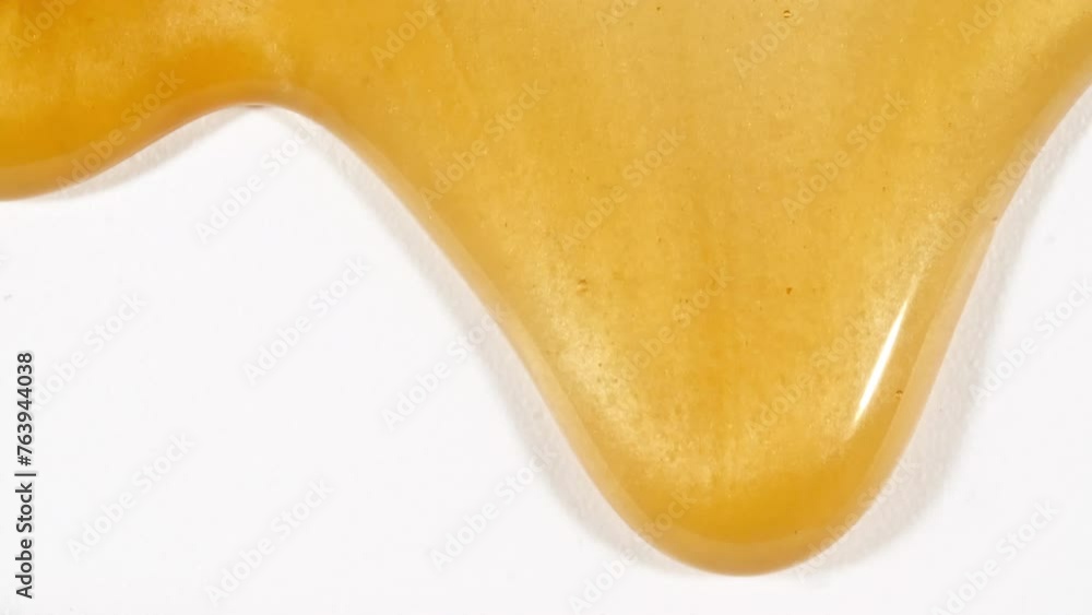 Yellow Cosmetic Gel Fluid With Molecule Bubbles Flowing On The Plain White Background. Liquid Cream Gel. Macro Shot of Natural Organic Cosmetics, Medicine. Production Close-up. Slow Motion. 4k Yellow Cosmetic Gel Fluid With Molecule Bubbles Flowing On The Plain White Background. Liquid Cream Gel. Macro Shot of Natural Organic Cosmetics, Medicine. Production Close-up. Slow Motion. 4k