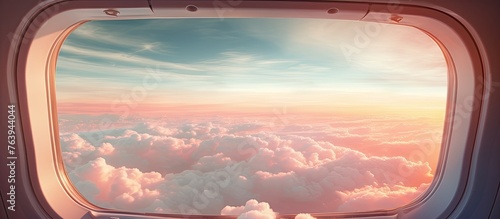 A close-up view of an airplane window with a clear view of the blue sky outside