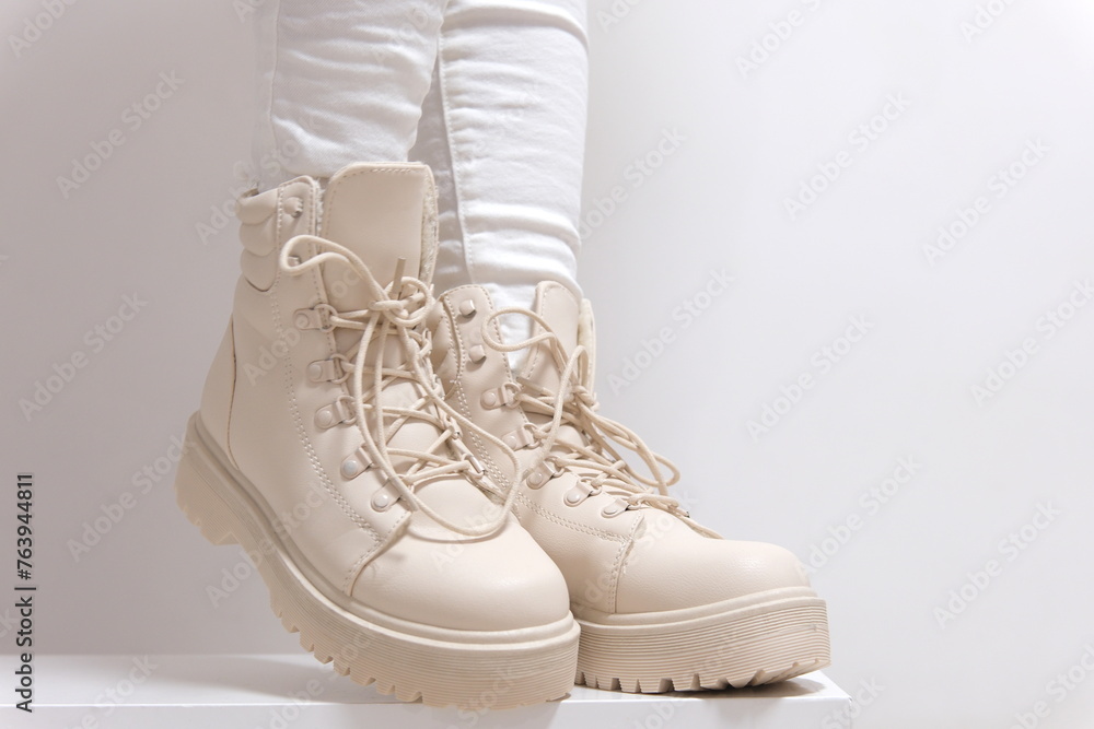 Light shoes women's boots with laces with high soles on a white background classic fashion show for purchase for winter autumn shoes store beige color milky color