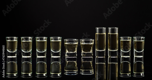 Strong alcoholic drink shots on a black background.