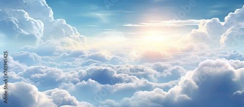 A view of a radiant sun casting its light over a sky filled with fluffy clouds photo