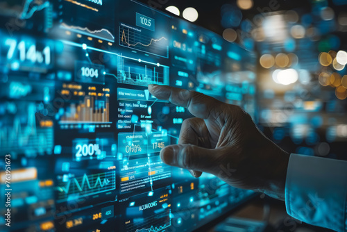 A hand is pointing at a computer screen with a lot of numbers and graphs