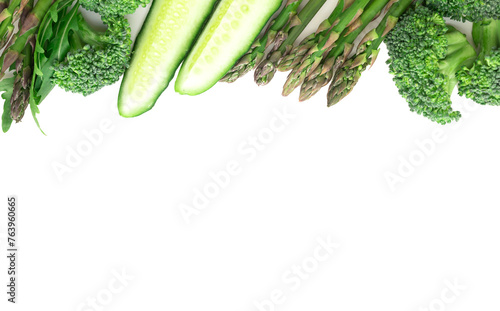 Frame of green vegetables broccoli, arugula, cucumber, asparagus and garlic on white background