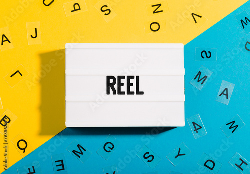 Reel word written in letters on a lightbox on duocolor photo