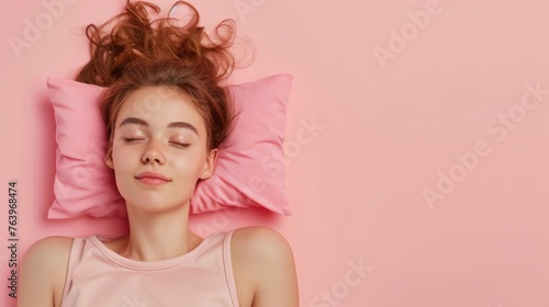 a young woman sleeping on pillow isolated on pastel pink colored background Sleep deeply peacefully rest. Top above high angle view photo portrait of satisfied .senior wear pink shirt