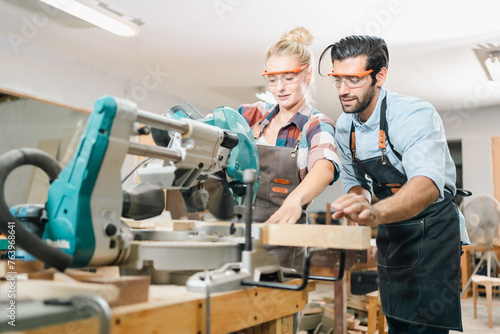 In a carpenter's shop, a skilled man with training in the craft uses tools to perform woodwork, blending occupation, industry, and business.