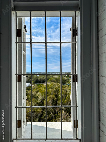 Lighthouse at St. Augustine  view out window form lighthouse-coastal landscape   Atlantic Coast of Florida  Lighthouse grounds with blue skies and clouds