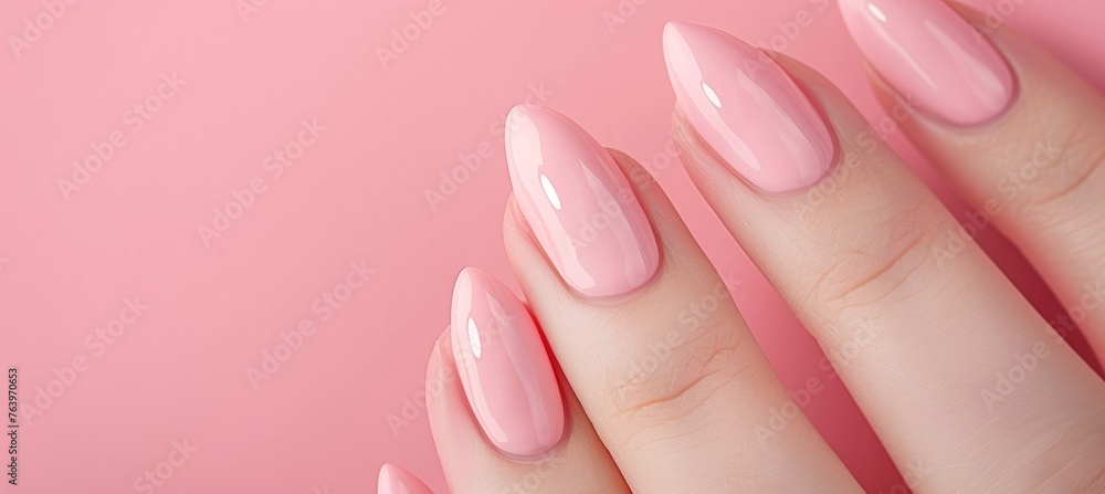 Detailed close up of woman s hand with chic pink nail polish for a glamorous look Detailed close up of woman s hand with chic pink nail polish for a glamorous look