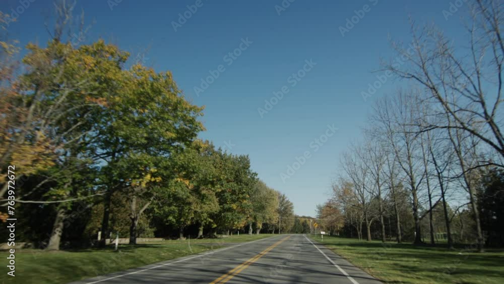 A trip by car on a clear autumn day, a view from the car window. Drive on a typical American road A trip by car on a clear autumn day, a view from the car window. Drive on a typical American road