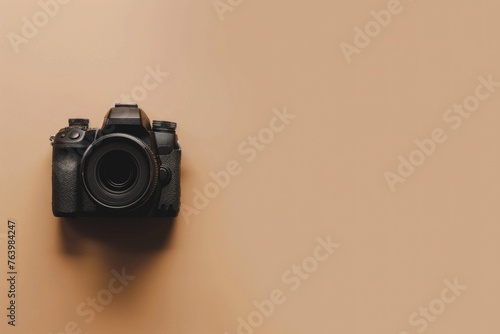 Photo camera on beige background, World Photography Day concept.