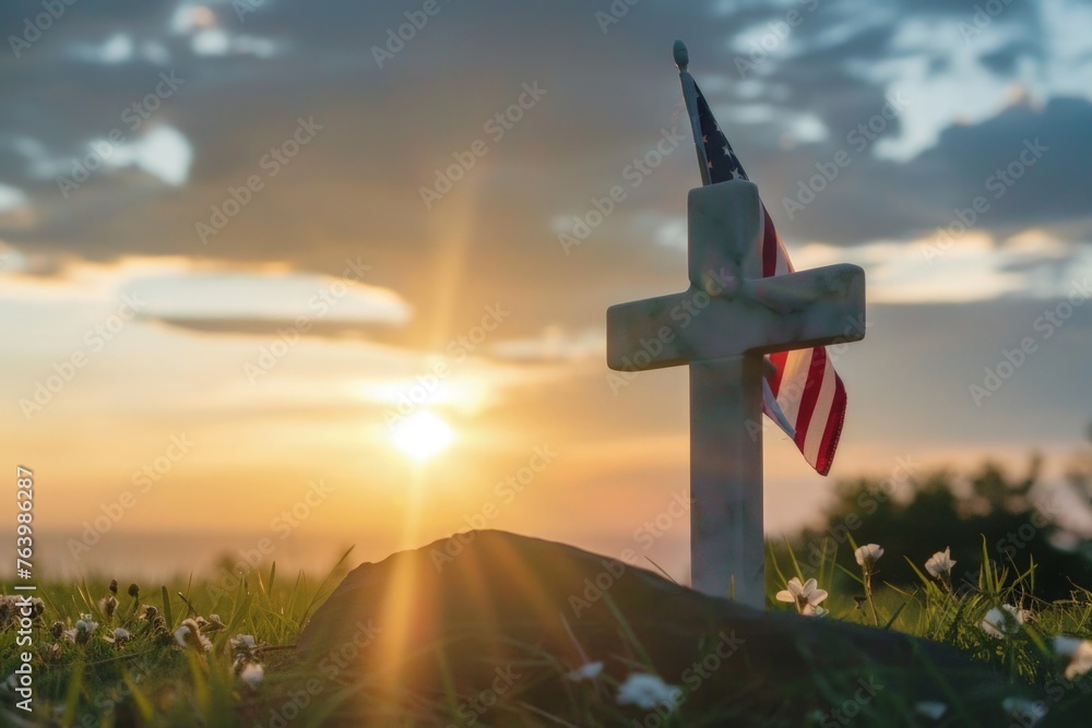 Obraz premium White cross on a hill with USA flag, sunset in the background, memorial day.