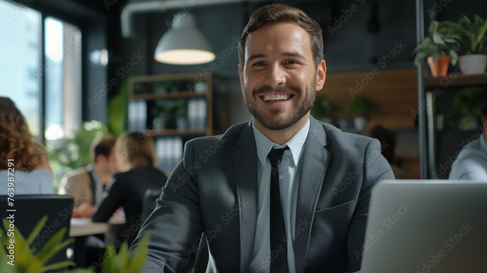 The moment of making a key decision: a businessman and his environment. Male workplace in an office in an open space with other colleagues The moment of making a key decision: a businessman and his environment. Male workplace in an office in an open space with other colleagues