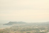 Film style photography showing a landscape in Alicante, Spain. In the picture you can see Benidorm, Altea and Mediterranean sea. It's taken form the mountains on a foggy day