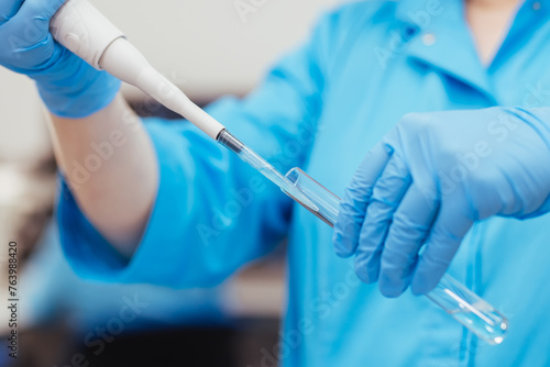 Medical research laboratory. A scientist works with a pipette and a test tube. Scientific laboratory of biotechnology, development of medicine and research in chemistry, biochemistry and experiments.