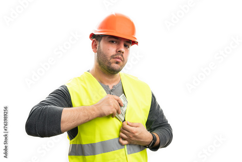 Serious  male builder hiding cash money inside fluorescent vest © Thunderstock
