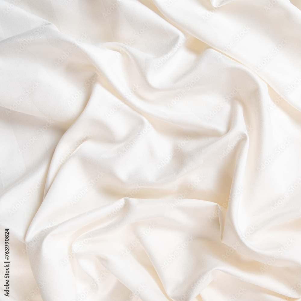 Waves and patterns of crumpled natural satin white milk color fabric. Waves and patterns of crumpled natural satin white milk color fabric.
