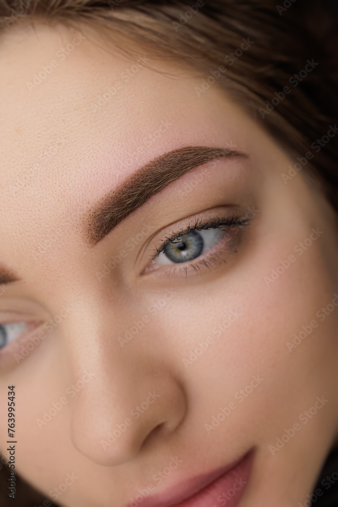Close-up of an eyebrow after correction of permanent eyebrow makeup. Second PMU procedure in a month of permanent eyebrow makeup. Permanent makeup correction. Close-up of an eyebrow after correction of permanent eyebrow makeup. Second PMU procedure in a month of permanent eyebrow makeup. Permanent makeup correction.