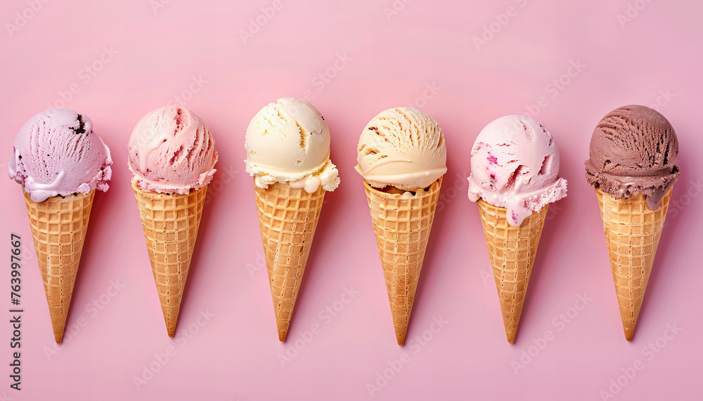 Row of ice creams scoops in a cone with different flavors on pastel pink background. Summer concept banner. Row of ice creams scoops in a cone with different flavors on pastel pink background. Summer concept banner.