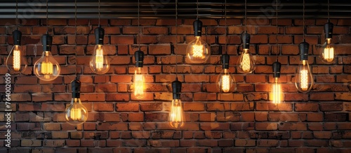 An art installation featuring a bunch of light bulbs hanging from a brick wall, illuminating the darkness with a warm glow, creating a unique event in a rustic building photo