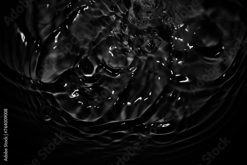 Image of black water surface with waves.