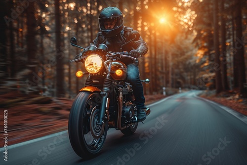 A motorcyclist riding a classic bike on a forest road during sunset, creating a sense of freedom